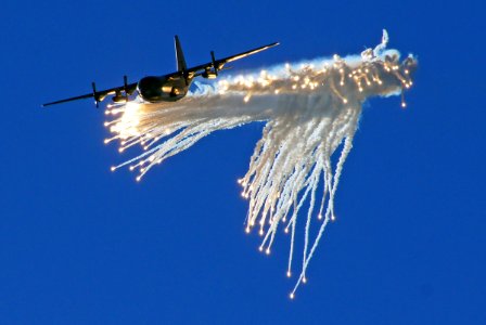 Lockheed C-130 Hercules Dropping flares.Warbirds show. photo