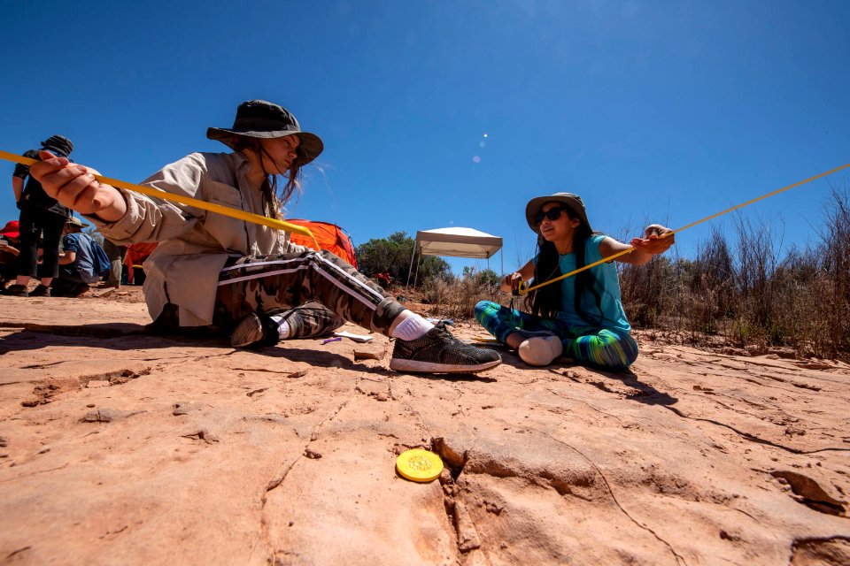 Cleaning and measuring tracks. Moab, UT. Photo by Eric Delphenich
