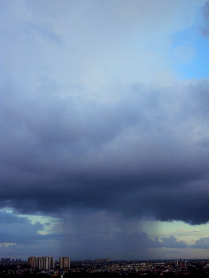 Tall cloud raining its shower