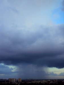 Tall cloud raining its shower