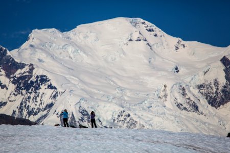 Mount Blackburn and Hikers on Root Glacier