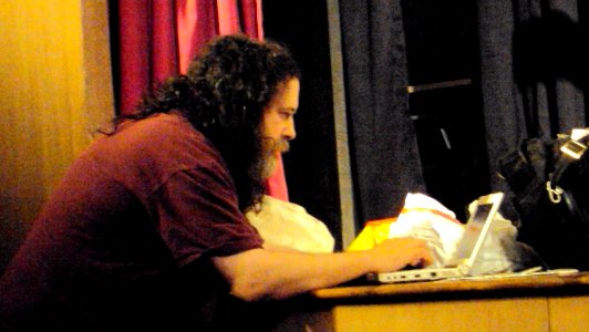 Richard Stallman working on his laptop before the talk began photo