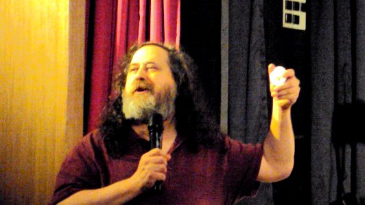 Richard Stallman selling GNU and FSF badges for fundraising photo
