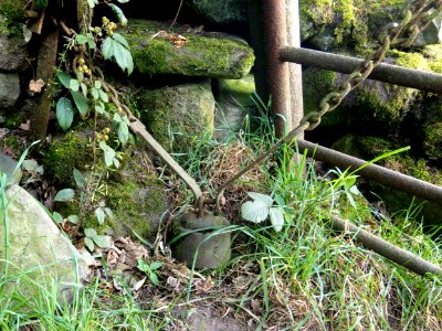 Concrete cylinder with unusual suspension apparatus.