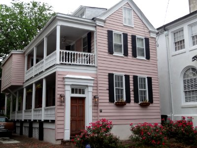 Charleston house painted pink house with red roses photo