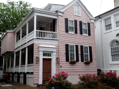 Charleston house painted pink house with red roses