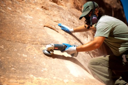 Park Maintenance Staff Use Grinders to Remove Graffiti
