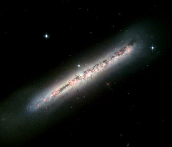 Glowing gas and dark dust in a side-on spiral