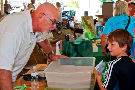 Brenden learns about animal paw prints from Bobby of the Corkscrew Regional Eco-system Watershed