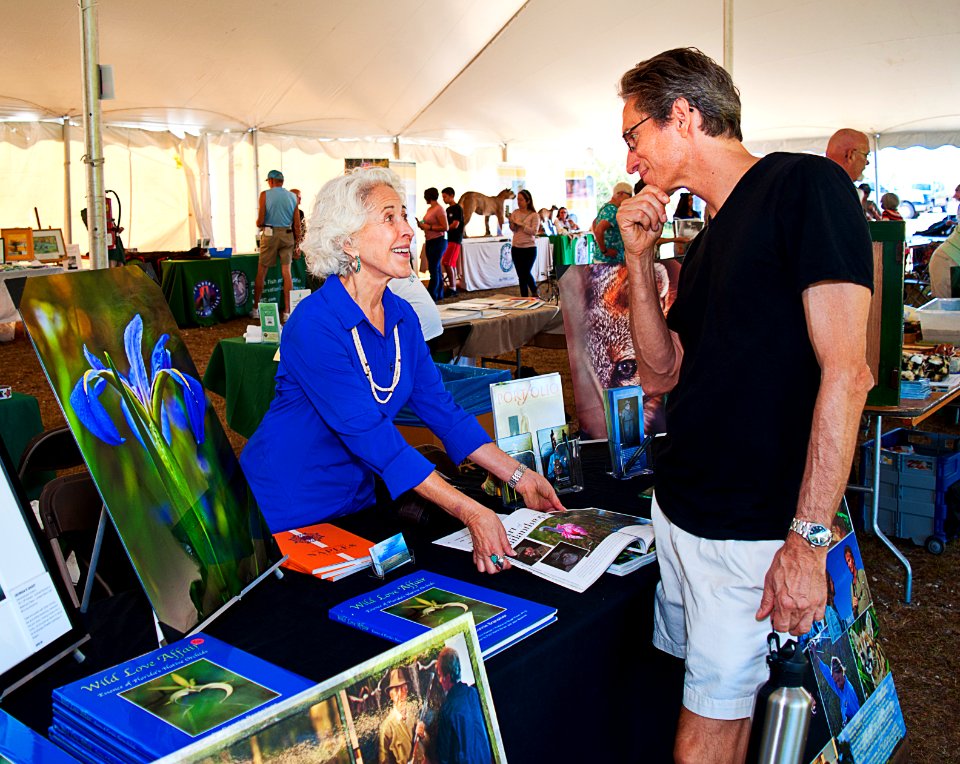 Connie - photographer for Guardians of the Everglades - shows Sean a recent publication of her work