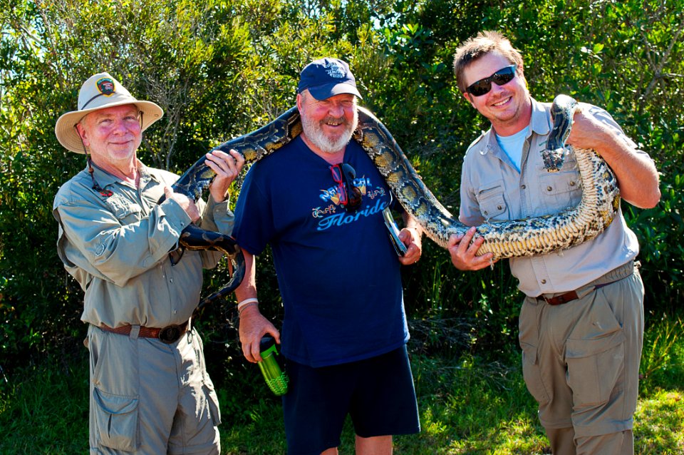 NPS Volunteer Wayne and Nick let Gaetan get up close and personal with an invasive python