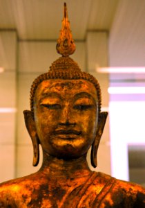 Statue of Lord Buddha, flame of wisdom, bust, Thai or Cambodian, San Francisco airport display, California, USA photo