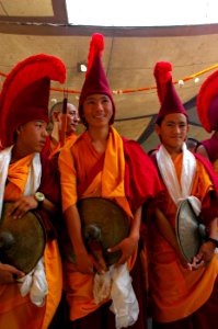 The Band playing cymbals prepares for playing at Tharlam Monastery of Tibetan Buddhism in the courtyard on Bodhisattva Day, Sakya Lamdre, Boudha, Kathmandu, Nepal photo