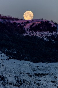 Full moon setting with morning alpenglow