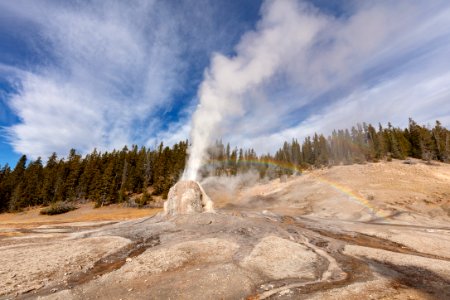 Fall morning Lone Star Geyser eruption with rainbow