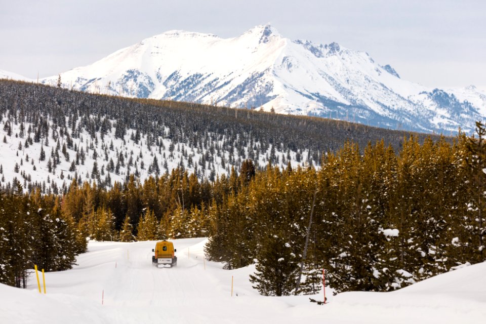 Snowcoach headed to Mammoth Hot Springs with Electric Peak in the distance