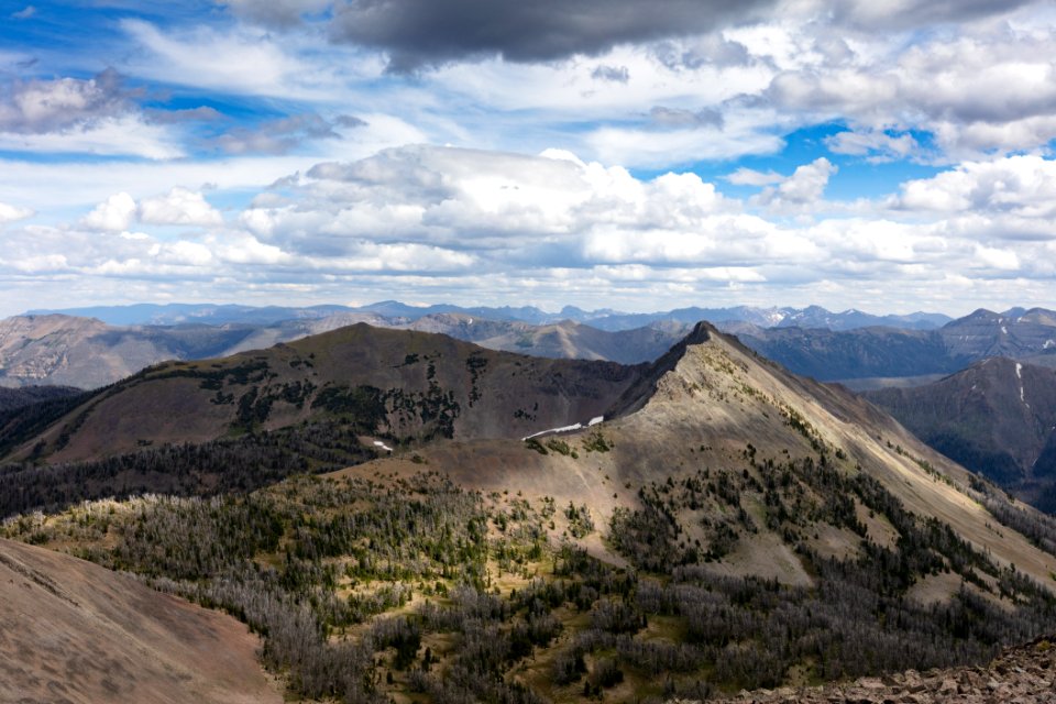 Sunlight peeks through the clouds onto Hoyt Peak