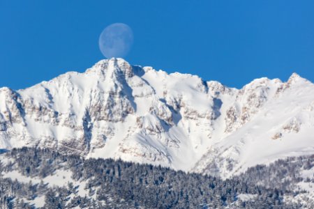 The moon "touches" the summit of Electric Peak