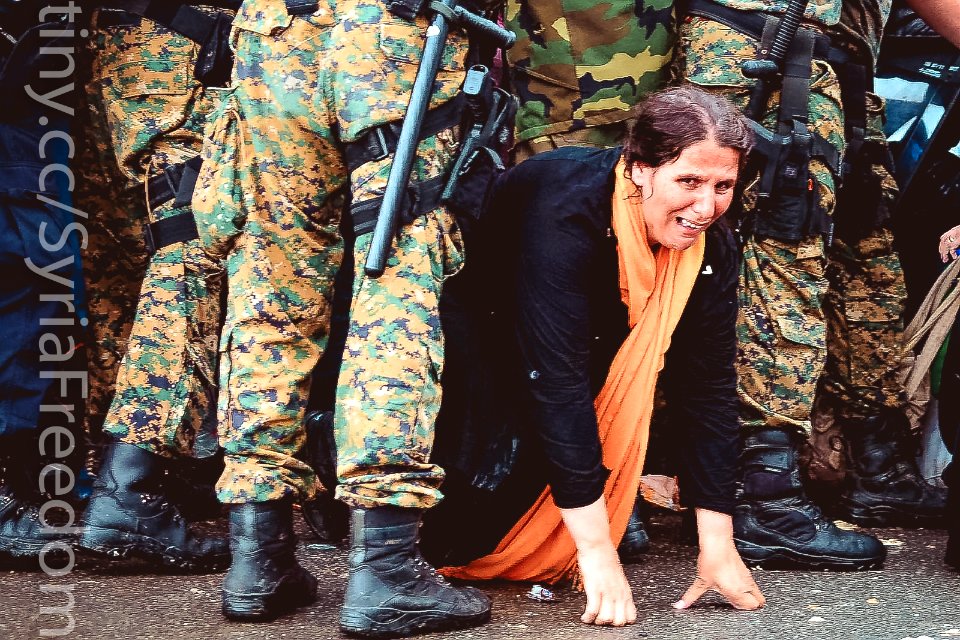 A woman cries as she crawls through a block of border police in the southern Macedonian town of Gevgelija, Sept. 10, 2015.