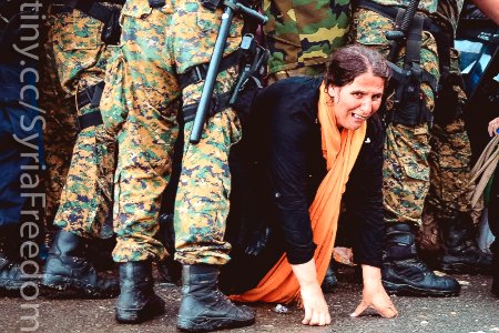 A woman cries as she crawls through a block of border police in the southern Macedonian town of Gevgelija, Sept. 10, 2015. photo