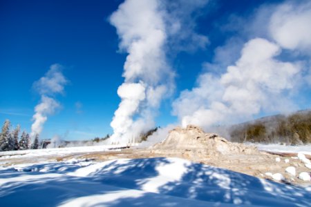 Grand Geyser erupts behind Castle Geyser
