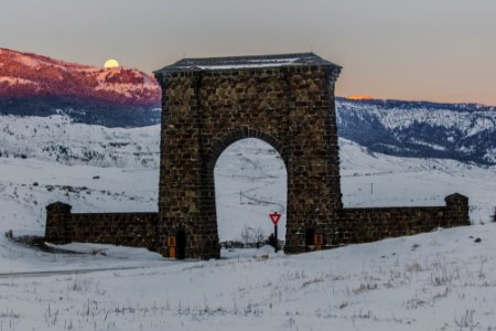 Full moon setting behind Roosevelt Arch