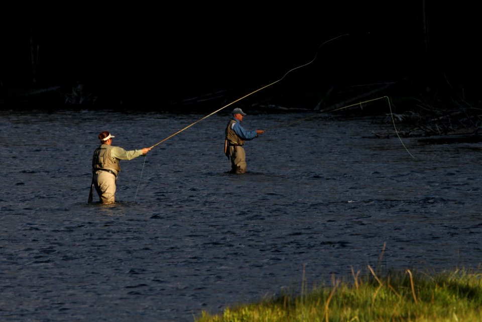 Visitors fishing the Firehole River
