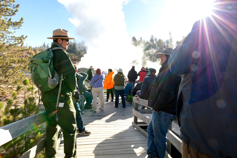 Ranger Mark Wolf chats with people at Steamboat Geyser minutes before an eruption