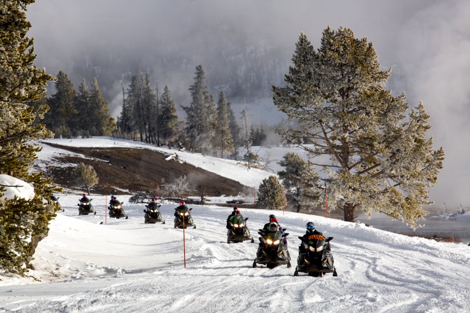 Guided snowmobile tour along Firehole River