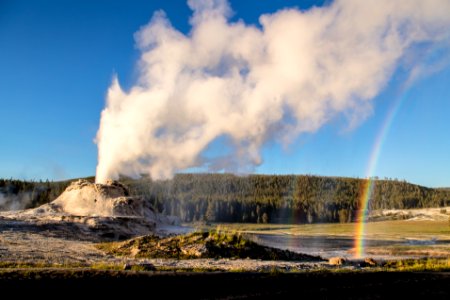 Castle Geyser eruption with double rainbow