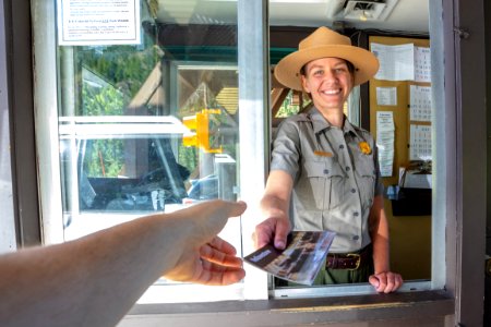 Ranger at East Entrance hands out a park map photo