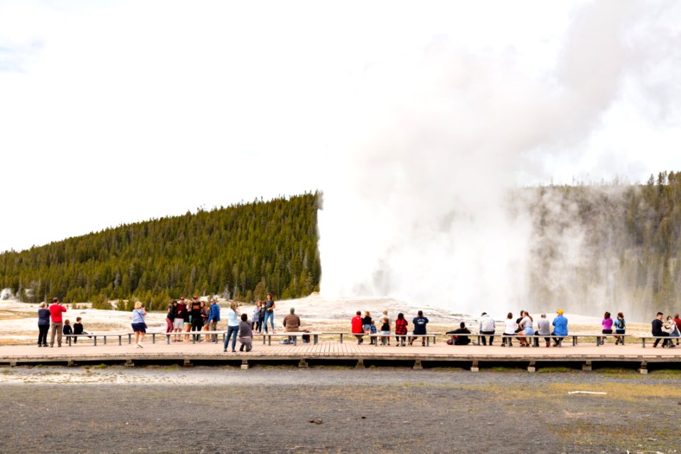 Visitors watch an Old Faithful Eruption Opening day 2020