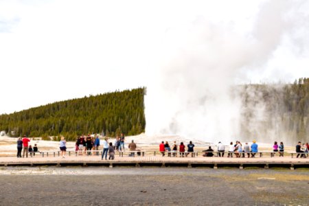 Visitors watch an Old Faithful Eruption Opening day 2020 photo