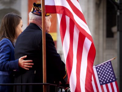 NEW YORK - NOV 11, 2014: An older US vet on a parade float holds an American Flag in the 2014 Americ photo