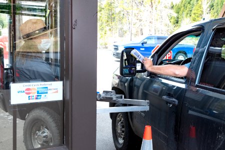 Park employee welcomes visitors at the East Entrance on Opening day 2020 (2) photo