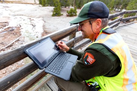 Physical Science Technician, Mark Wolf, downloads data from a remote temperature logger photo