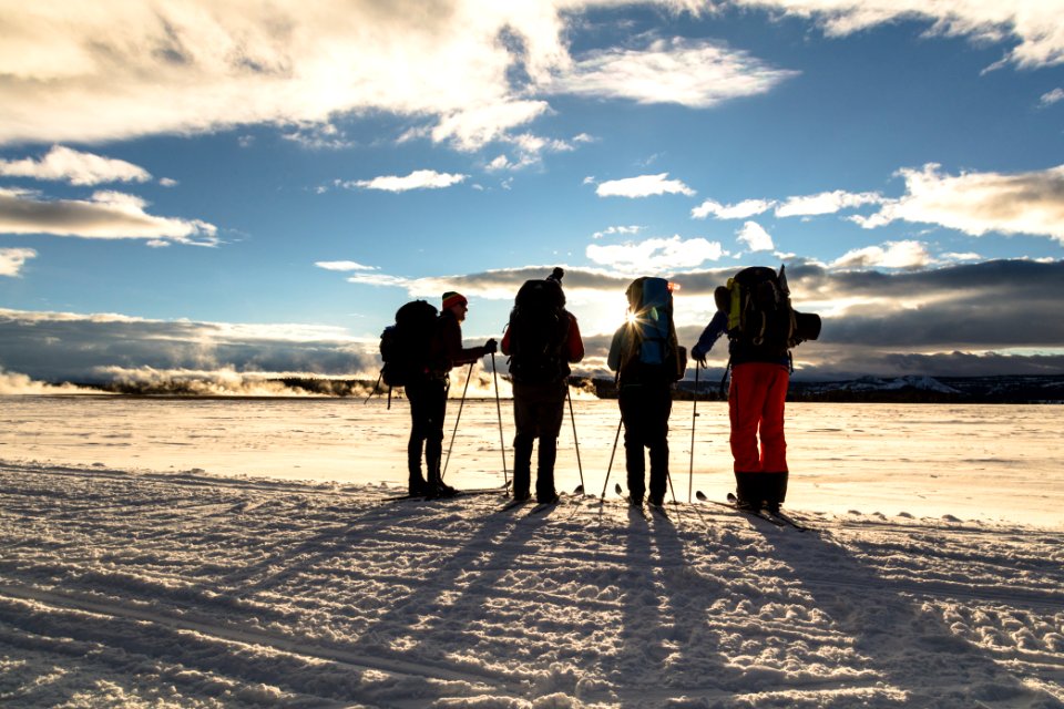 Backcountry campers watch the sunset in Lower Geyser Basin from the road.