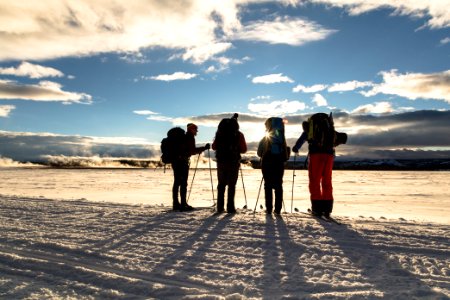 Backcountry campers watch the sunset in Lower Geyser Basin from the road.