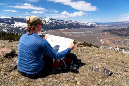 Hiker overlooking the Soda Butte Creek and Lamar River confluence with map photo