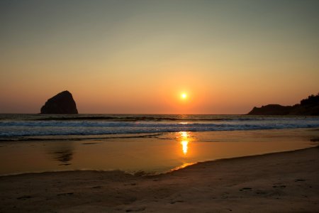 Golden sunset at Cape Kiwanda, Oregon photo