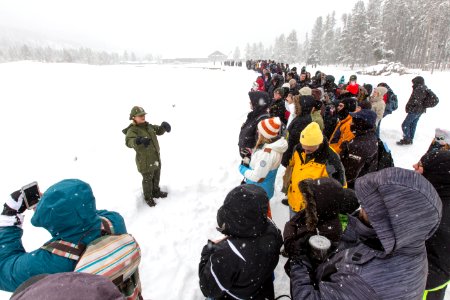 Ranger Roland giving an interpretive program while people wait for Old Faithful's next eruption