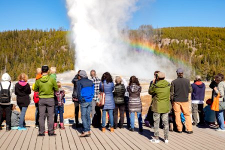 Old Faithful eruption and rainbow