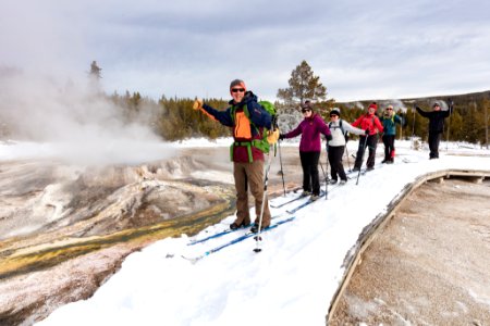 Skiers take in the views of Punch Bowl Spring from the boardwalk