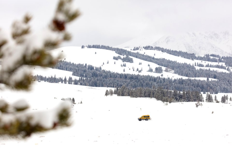 Snow coach driving through Swan Lake Flats