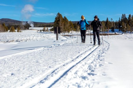 Two visitors ski out to Castle Geyser photo
