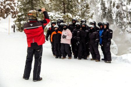 Guide takes a photo for a group at Firehole Falls photo