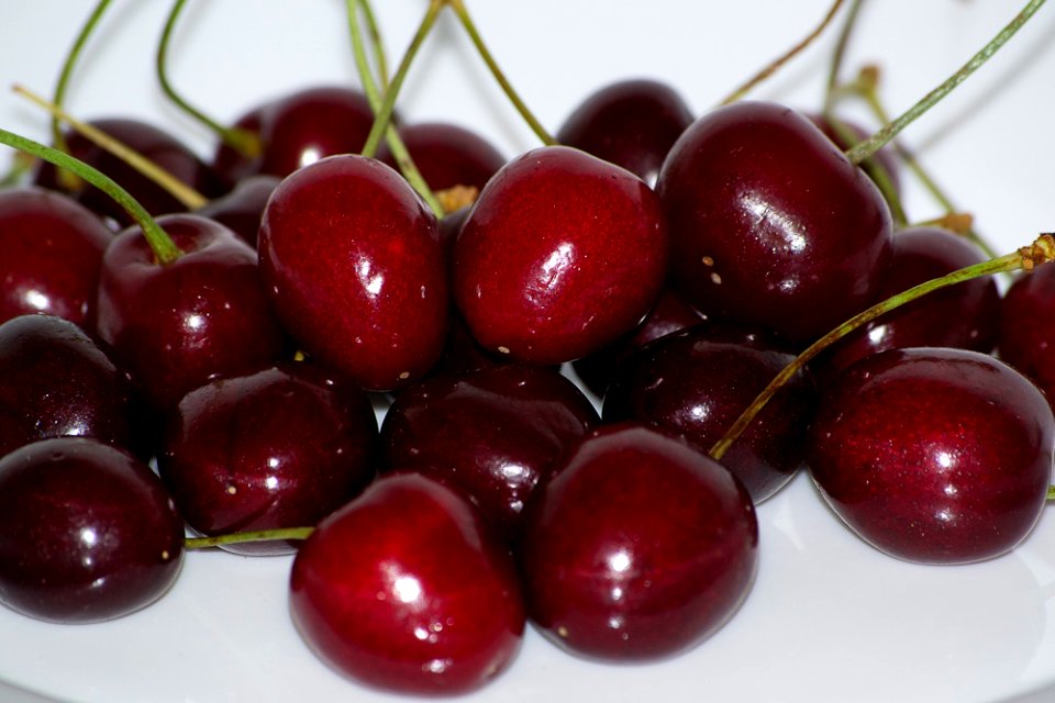Bunch of cherries on a white plate