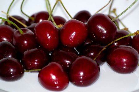 Bunch of cherries on a white plate