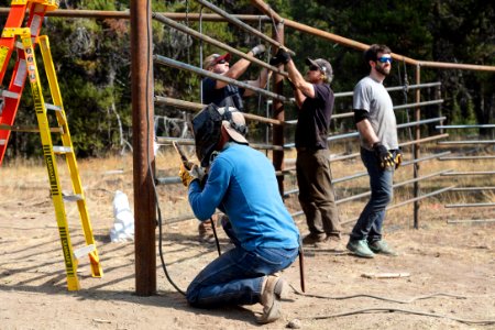 Canyon Corral volunteer project: tacking fencing into place