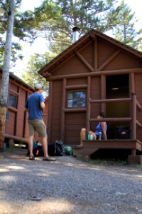 Roosevelt Lodge, visitors in front of a cabin